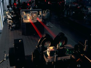 The PRIMA instrument for the VLT Interferometer is shown here during testing in Garching. The two combined beams of the PRIMA fringe sensor unit (FSU) B are seen, in red metrology laserlight, joining the FSU’s beam combiner in the background to the fibre injection optics. When complete the facility is expected to provide improvements in VLTI sensitivity, along with astrometry to better than 100 microarcseconds.